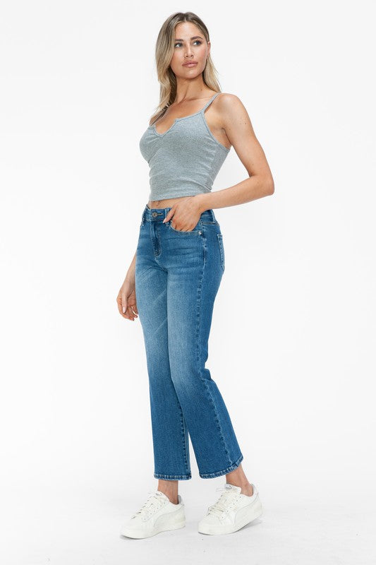 Model wearing bytos Cat's Whiskers mid-rise ankle jeans with a gray tank top and white sneakers.