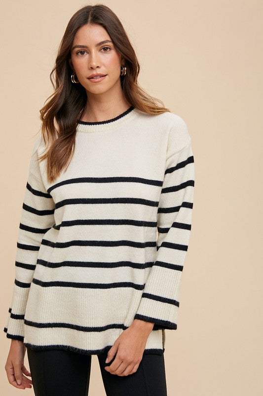 Stylish striped round neck sweater with side slits, perfect for cozy and modern outfits.