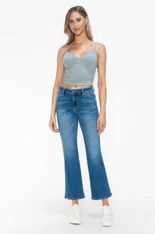 Model wearing bytos Cat's Whiskers Mid Rise Ankle Jeans paired with a gray crop top and white sneakers.