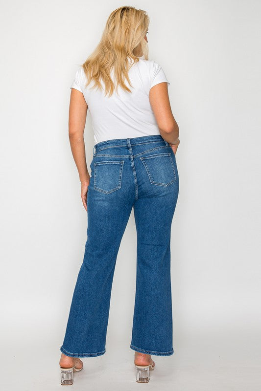 Woman wearing mid-rise ankle jeans with a white t-shirt, showcasing a stylish back view.