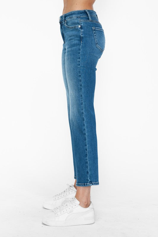 Side view of bytos Cat's Whiskers mid rise ankle jeans, featuring a sleek fit and modern style, paired with white sneakers.