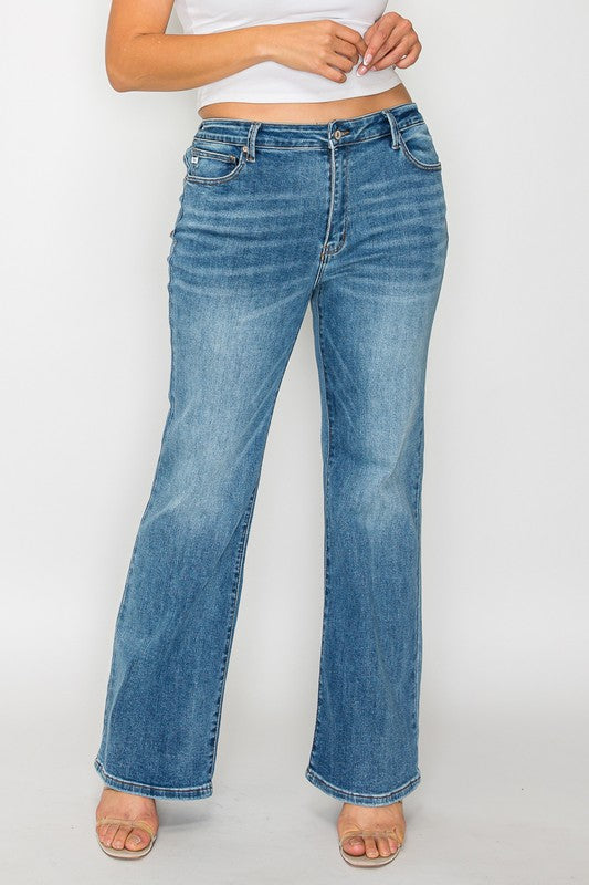 Model wearing bytos Cat's Whiskers mid-rise bootcut jeans in light wash, showcasing stylish and flattering fit.