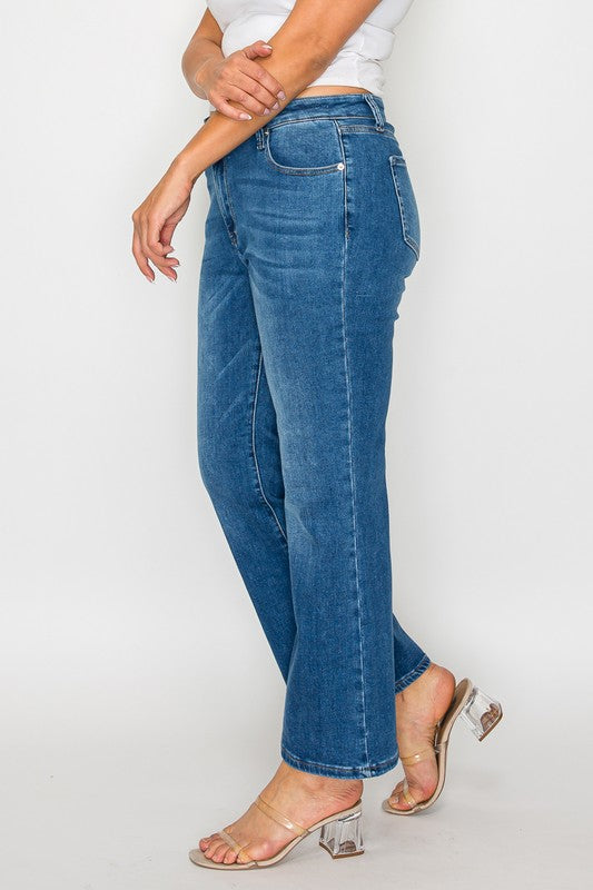 Stylish model showcasing bytos Cat's Whiskers Mid Rise Ankle Jeans in a trendy blue wash with a modern ankle cut.