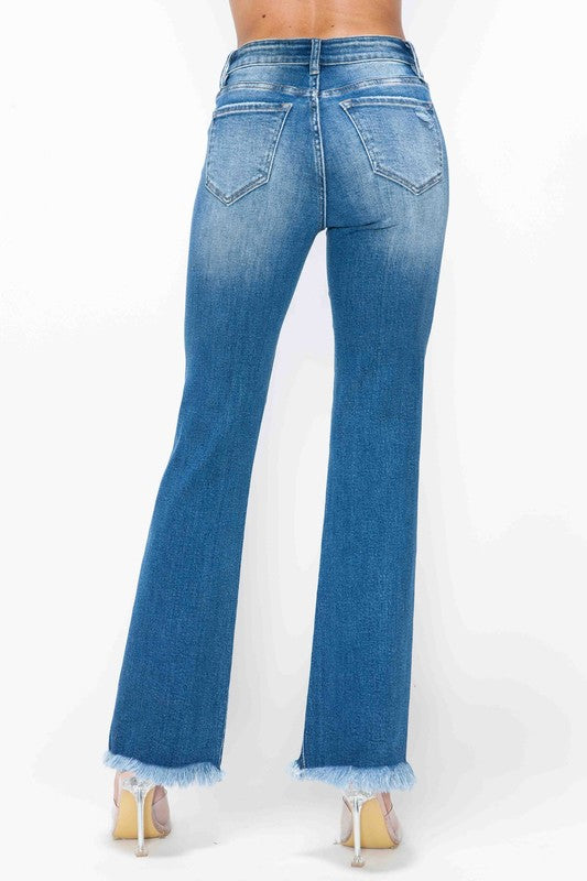 Back view of bytos Full Size Raw Hem Distressed High Rise Bootcut Jeans showcasing the raw hem and slight flare.